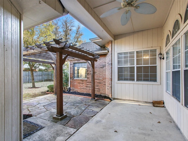 view of patio with fence, a ceiling fan, and a pergola