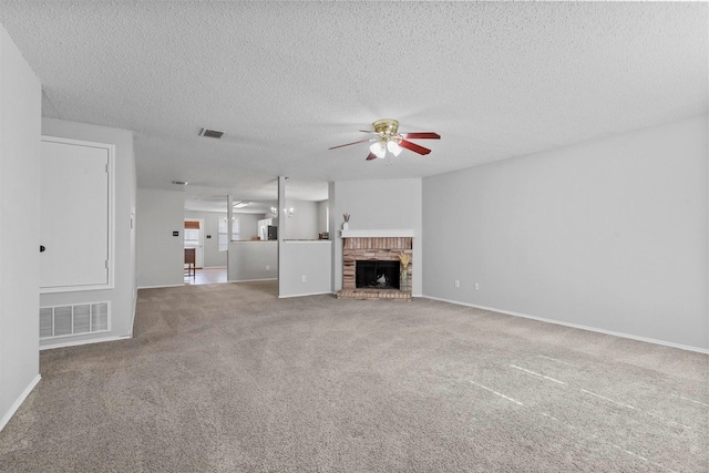 unfurnished living room featuring a brick fireplace, ceiling fan, visible vents, and carpet