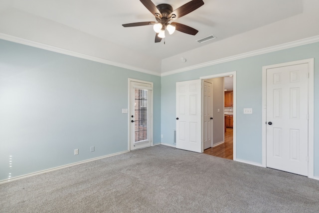 unfurnished bedroom featuring visible vents, ornamental molding, access to outside, carpet flooring, and vaulted ceiling