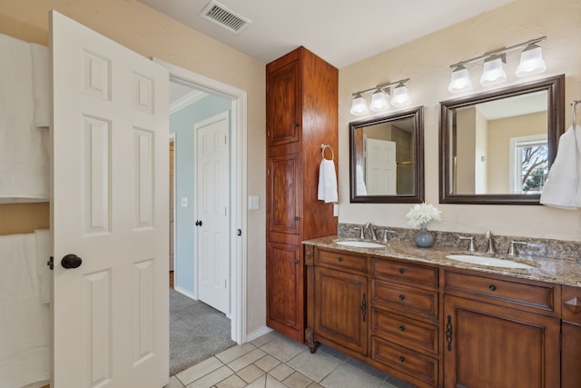 full bath featuring a sink, visible vents, double vanity, and tile patterned flooring