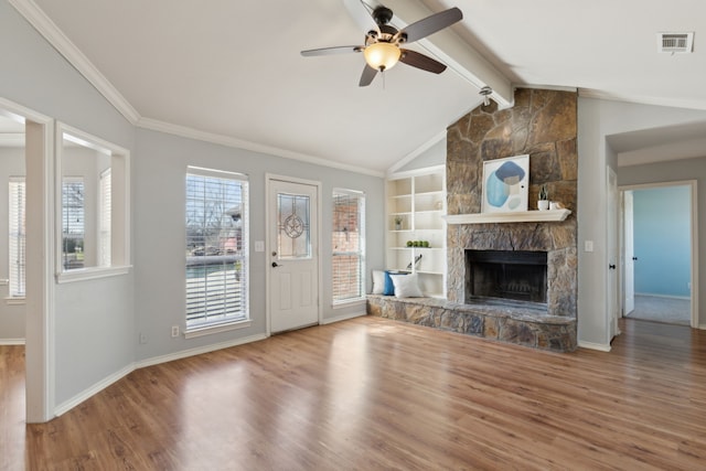 unfurnished living room with lofted ceiling with beams, visible vents, plenty of natural light, and wood finished floors