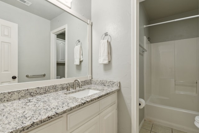 full bath featuring vanity, visible vents, tile patterned flooring, bathtub / shower combination, and toilet