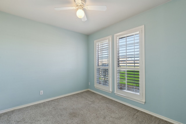 unfurnished room featuring carpet flooring, baseboards, and a ceiling fan