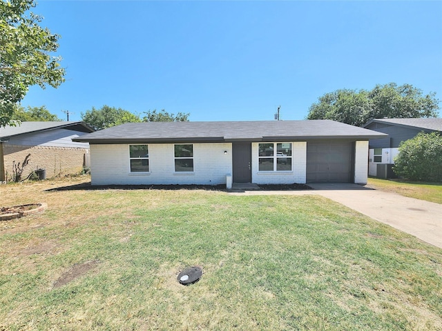 ranch-style house with brick siding, an attached garage, fence, driveway, and a front lawn