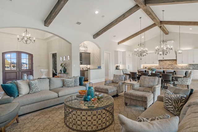 living area featuring visible vents, arched walkways, french doors, high vaulted ceiling, and a notable chandelier