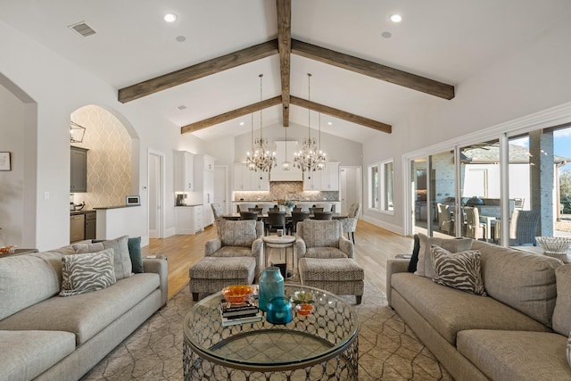 living room with a chandelier, light wood-type flooring, visible vents, and recessed lighting