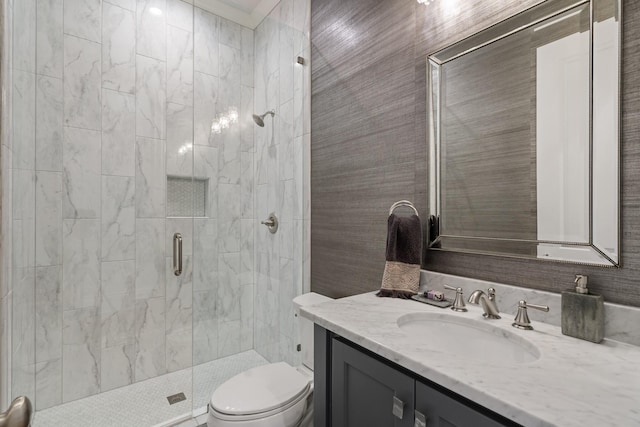 full bathroom with vanity, a shower stall, and toilet