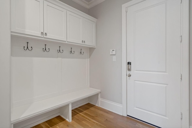 mudroom with light wood finished floors and baseboards