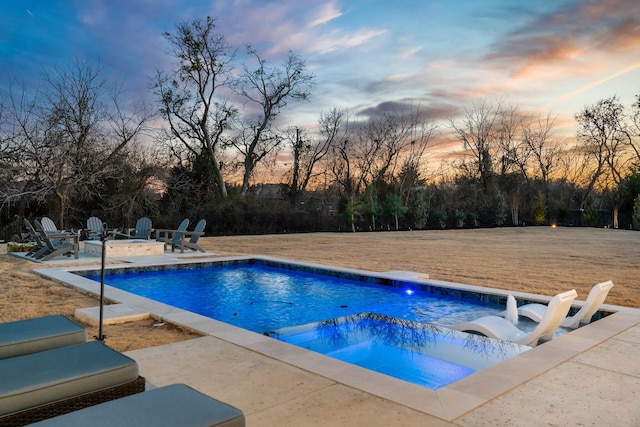 outdoor pool featuring a patio area and an outdoor fire pit