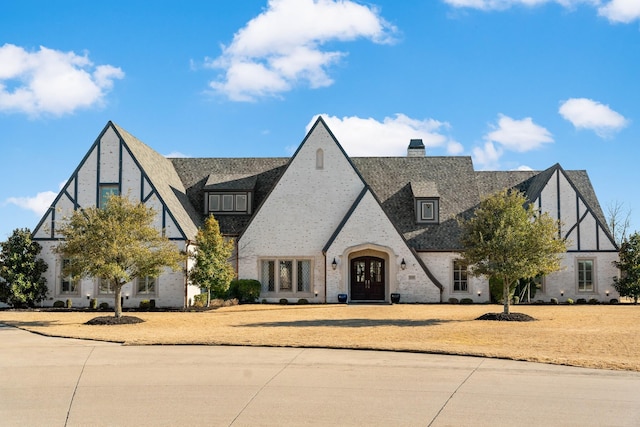 view of front of property with a chimney and a front yard