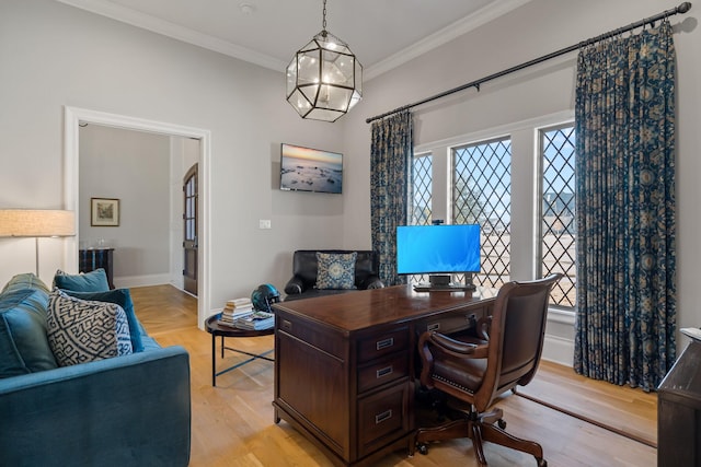 office with baseboards, ornamental molding, light wood-type flooring, and a healthy amount of sunlight