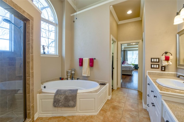 full bath with connected bathroom, ornamental molding, a tile shower, vanity, and a bath