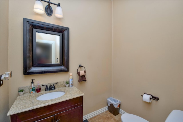 half bath featuring toilet, tile patterned flooring, baseboards, and vanity