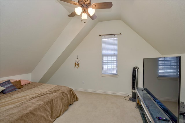 carpeted bedroom featuring ceiling fan, baseboards, and vaulted ceiling