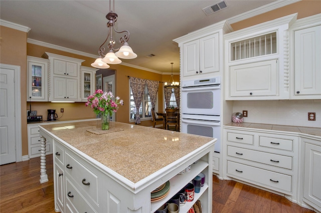 kitchen with white double oven, dark wood-style flooring, visible vents, white cabinetry, and open shelves