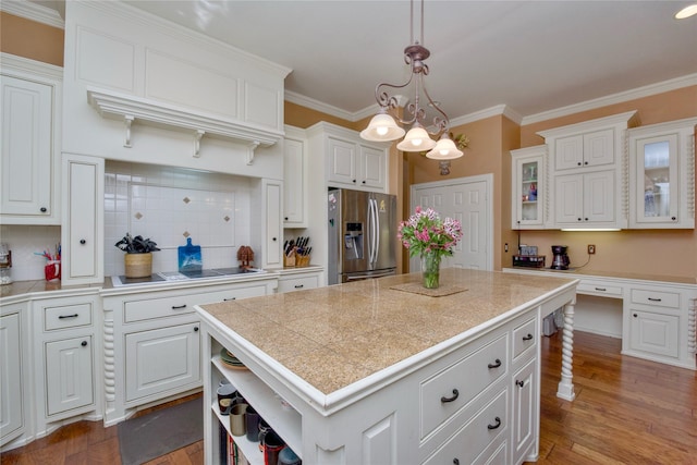 kitchen with wood finished floors, white cabinets, open shelves, stainless steel fridge, and crown molding