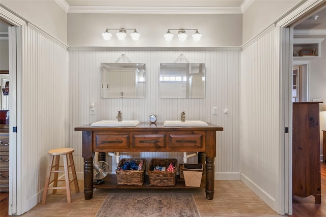 bathroom with ornamental molding, wood tiled floor, a sink, and double vanity