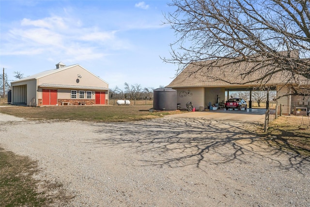 exterior space featuring a carport, driveway, and a yard