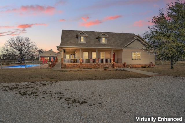 view of front of home featuring covered porch and an outdoor pool