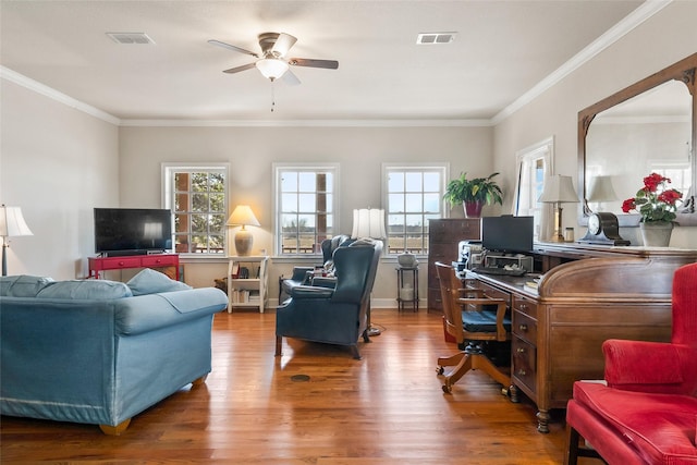 interior space featuring a healthy amount of sunlight, visible vents, and wood finished floors