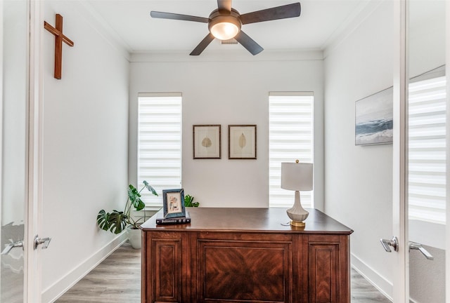 home office featuring light wood-style floors, ceiling fan, crown molding, and french doors