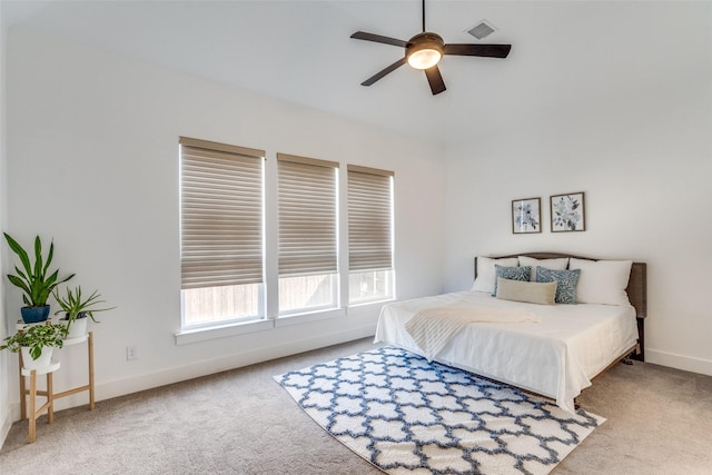 carpeted bedroom with visible vents, ceiling fan, and baseboards