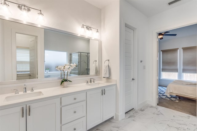 ensuite bathroom with marble finish floor, ensuite bath, a sink, and a shower stall