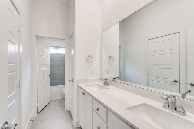 full bathroom with double vanity, a sink, and tile patterned floors