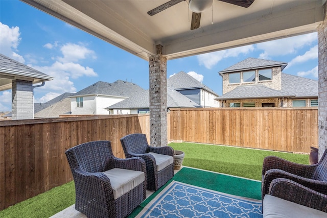 view of patio with a fenced backyard and a ceiling fan