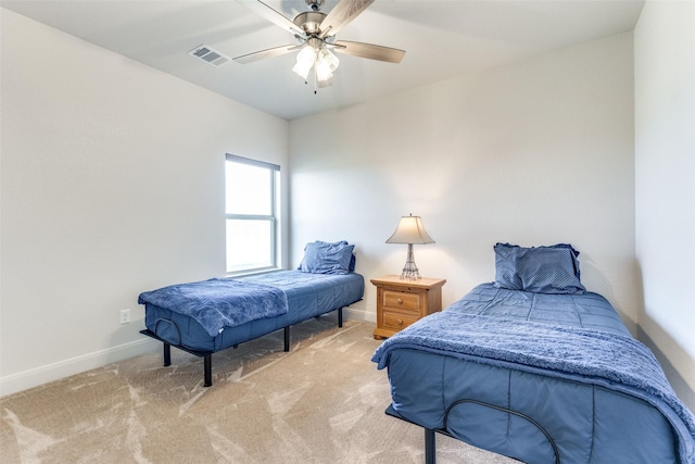 bedroom with carpet floors, visible vents, baseboards, and a ceiling fan