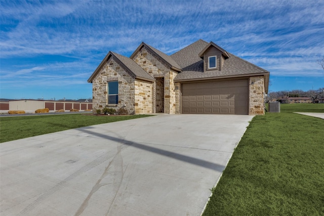 648 Half Moon Way, Runaway Bay, TX 76426 - french country style house featuring stone siding, a front lawn, and an attached garage
