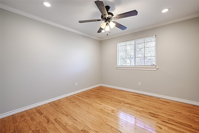 unfurnished room with crown molding, light wood-style flooring, and baseboards