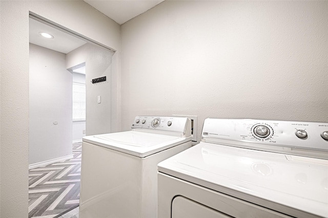 washroom with laundry area, independent washer and dryer, and baseboards