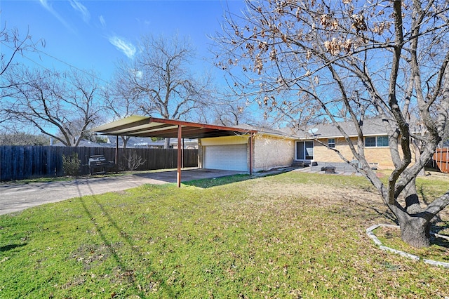 exterior space featuring a carport, fence, concrete driveway, and brick siding