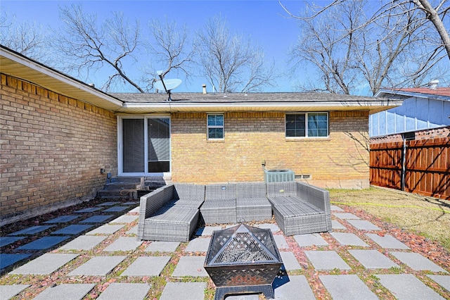 view of patio / terrace featuring entry steps, an outdoor living space with a fire pit, and fence