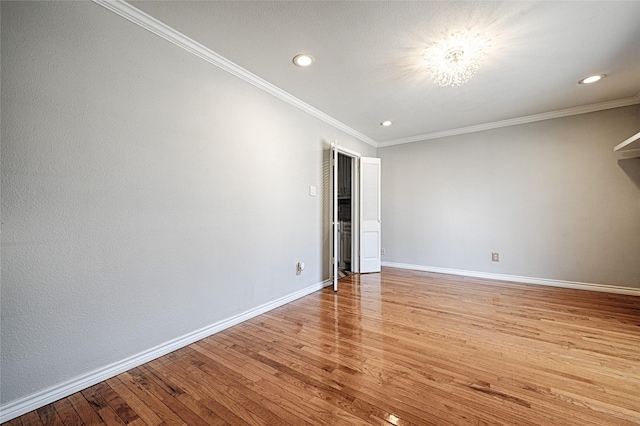 spare room with light wood finished floors, recessed lighting, baseboards, and ornamental molding