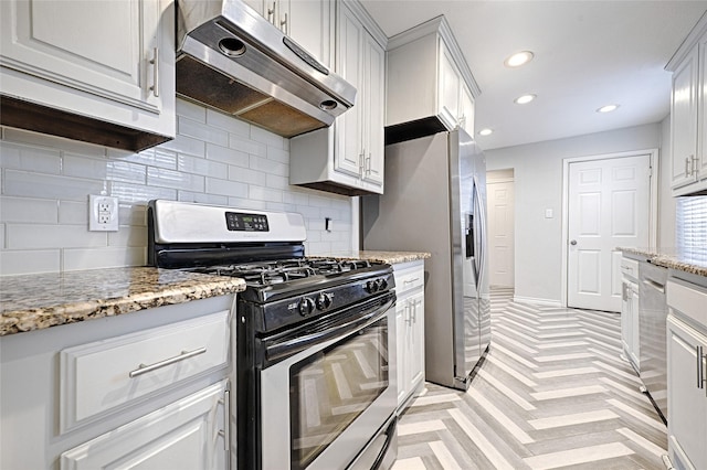 kitchen featuring light stone counters, recessed lighting, under cabinet range hood, appliances with stainless steel finishes, and tasteful backsplash