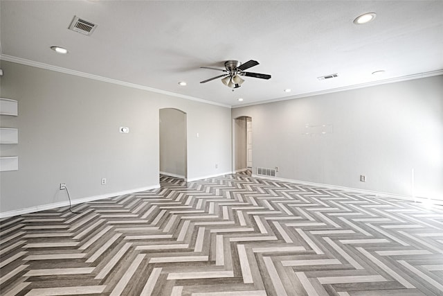 empty room with baseboards, visible vents, arched walkways, and a ceiling fan