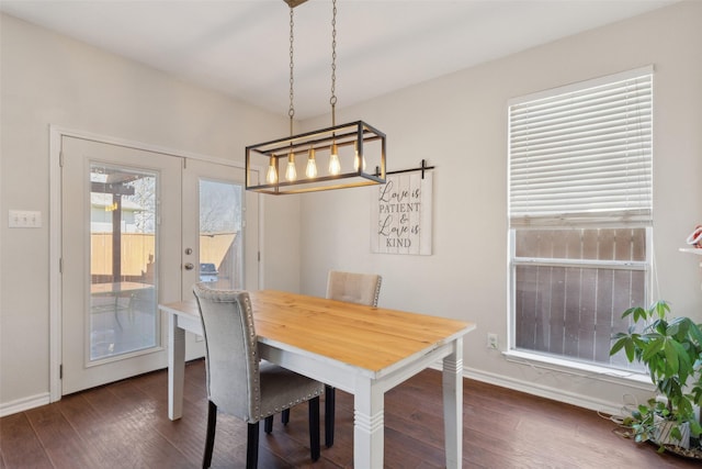 dining area with dark wood-style floors, baseboards, and french doors