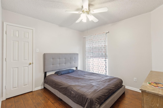 bedroom featuring a textured ceiling, hardwood / wood-style floors, and baseboards