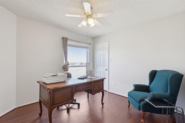 home office featuring ceiling fan, a textured ceiling, wood finished floors, and baseboards