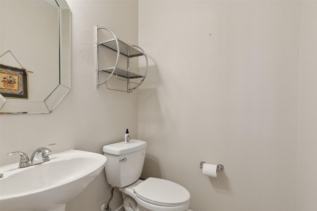 half bath with a sink and toilet