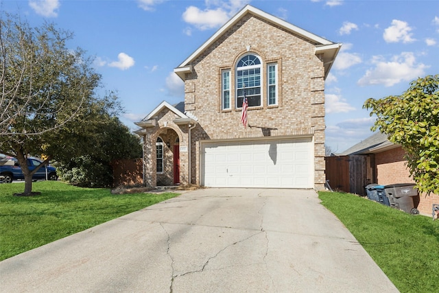 traditional-style home with an attached garage, brick siding, fence, driveway, and a front yard