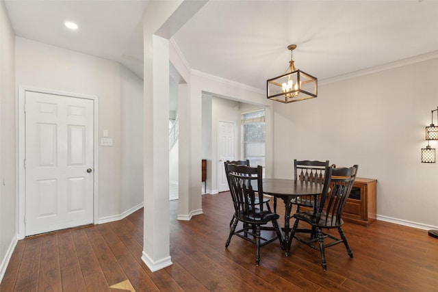 dining space featuring ornamental molding, dark wood finished floors, baseboards, and an inviting chandelier