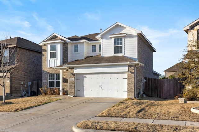 traditional home with a garage, concrete driveway, brick siding, and fence