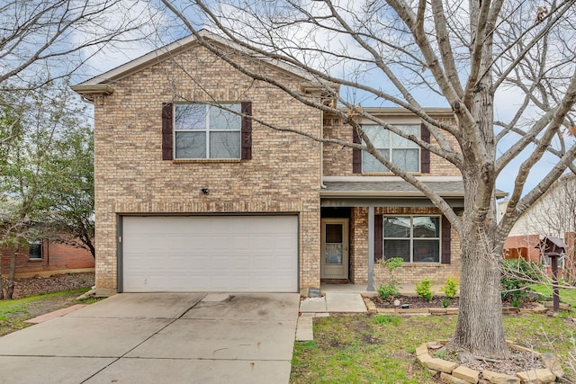 traditional-style home featuring a garage, driveway, and brick siding