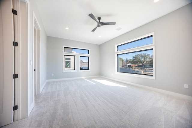 unfurnished bedroom featuring ceiling fan, recessed lighting, light colored carpet, visible vents, and baseboards