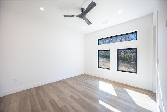 spare room featuring recessed lighting, visible vents, ceiling fan, light wood-type flooring, and baseboards