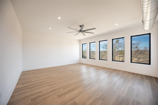 spare room with a ceiling fan, recessed lighting, baseboards, and light wood finished floors