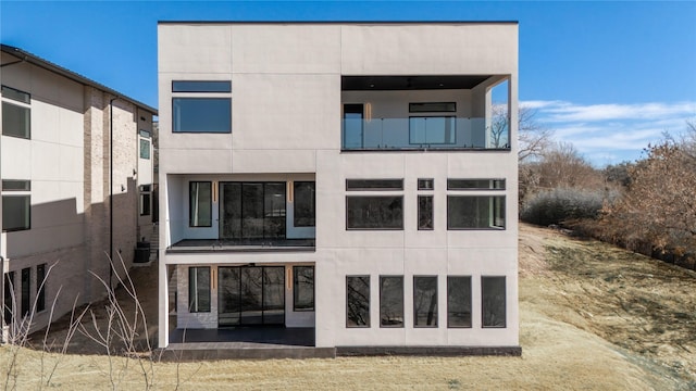 back of house with stucco siding